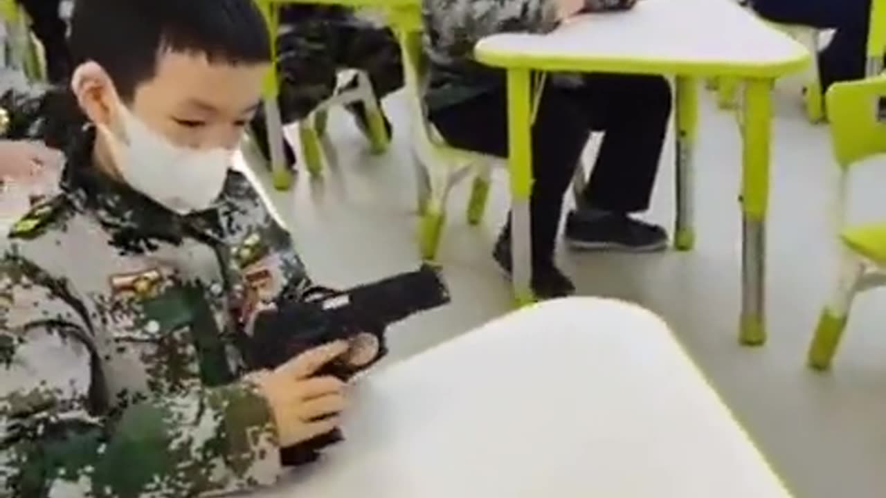 Chinese children learning to strip guns down (in school?)