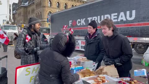 Two students are giving out food and supplies to anyone who needs it at the Trucker Convoy in Ottawa