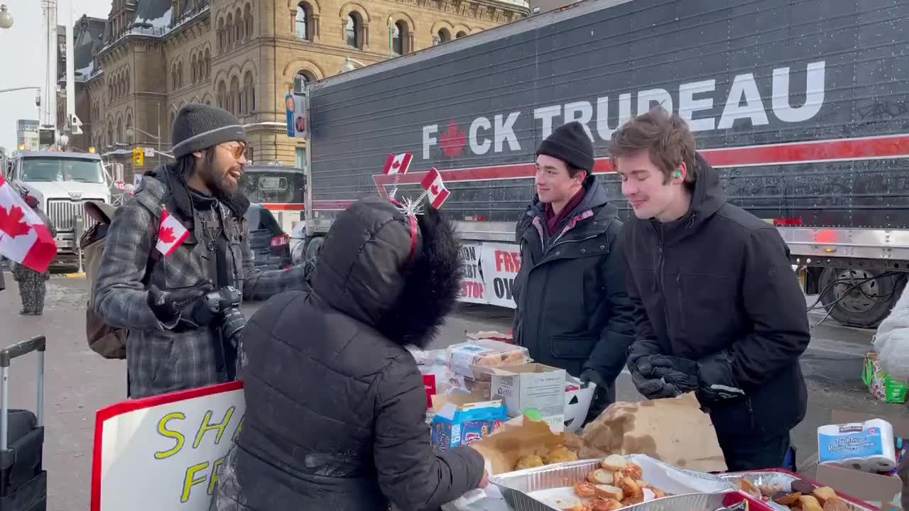Two students are giving out food and supplies to anyone who needs it at the Trucker Convoy in Ottawa