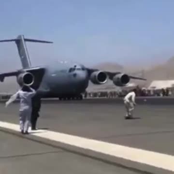 Afghan Civilians on Wheelhub of Departing Air Force Plane During Kabul Evacuation Aug. 16, 2021