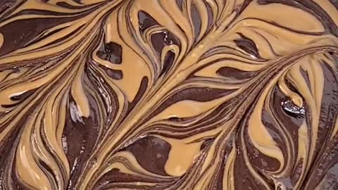 Fudgy, gooey Brownies topped with Biscoff swirls and Biscoff cookies