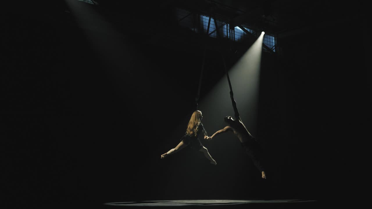 Circus performers on ropes