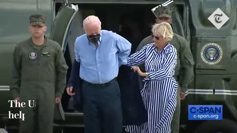 Joe Biden struggles to get his jacket on before dropping his sunglasses_1