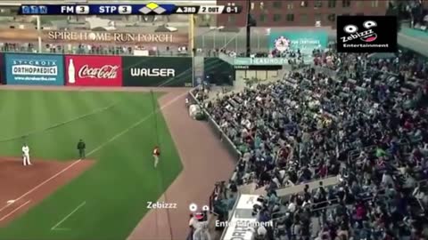 A baseball bat flew into the crowd, man caught the bat with one hand without spilling his beer