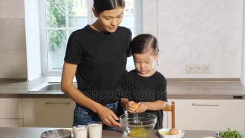 Cut girl cooking with mother