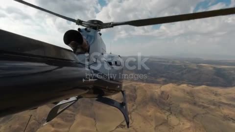 A US Army helicopter flies over the mountains in Afghanistan.