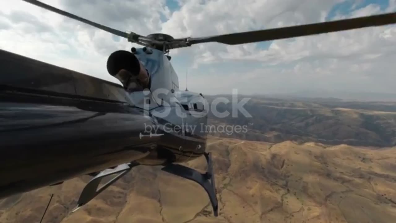 A US Army helicopter flies over the mountains in Afghanistan.
