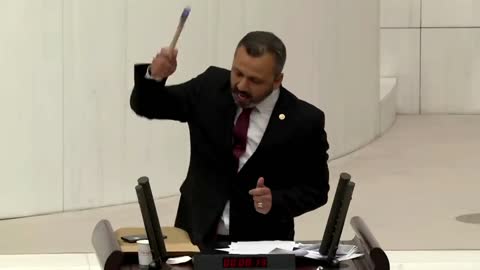 Turkish lawmaker smashes phone with hammer in parliament to protest social media bill