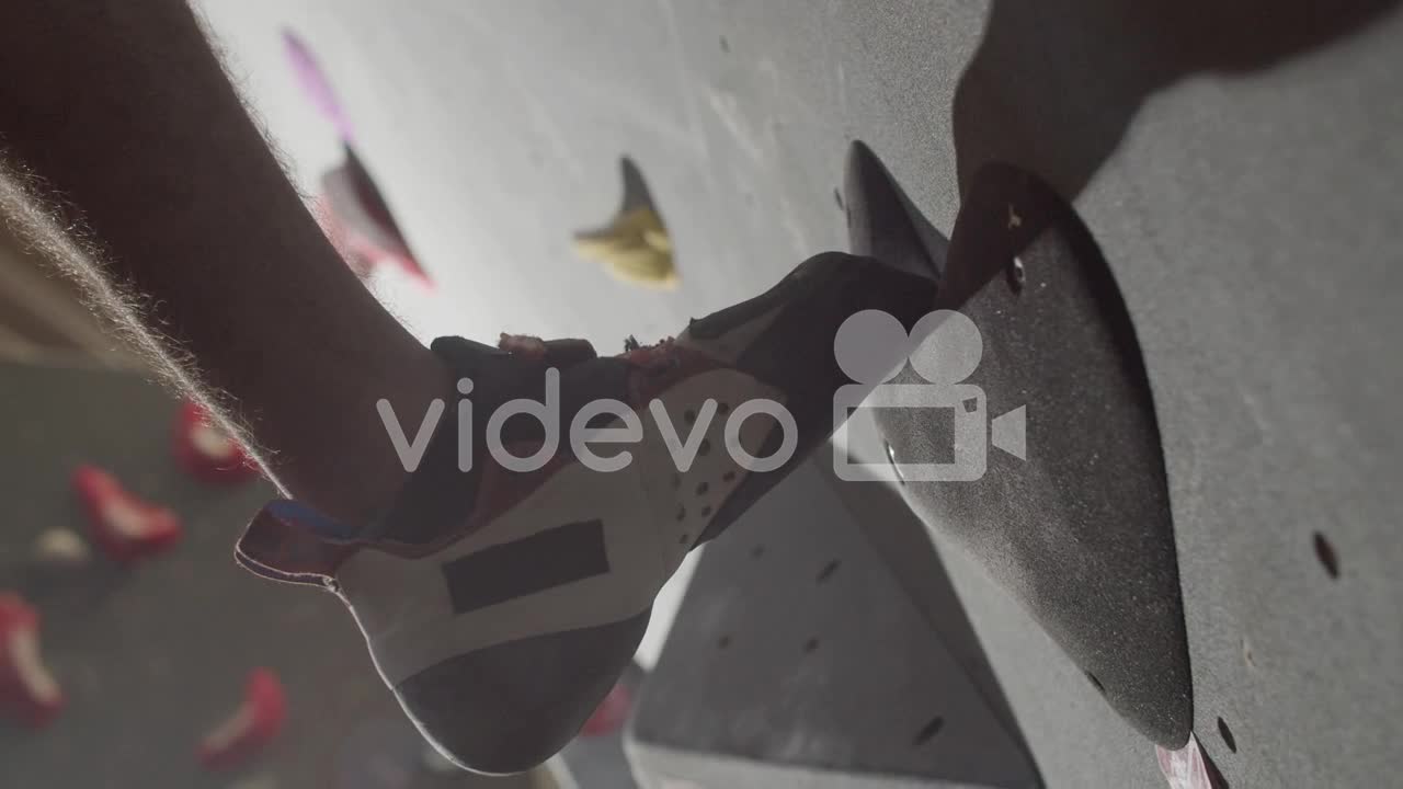 Close Up Shot Of An Unrecognizable Male Sportsman Climbing Up Bouldering Wall Indoors