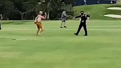 Attention seeking on the golf course and gets tackled.