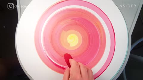 Ceramist Evenly Paints Designs Onto Spinning Pottery