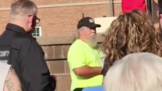 The election official tried to get him to take his Make America Great Again hat off in order to vote