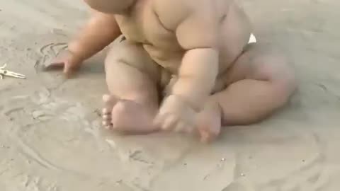 Baby playing in sand