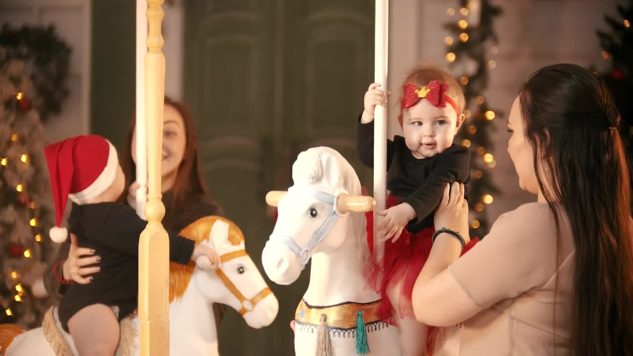 Mothers with their daughters on a Christmas carousel