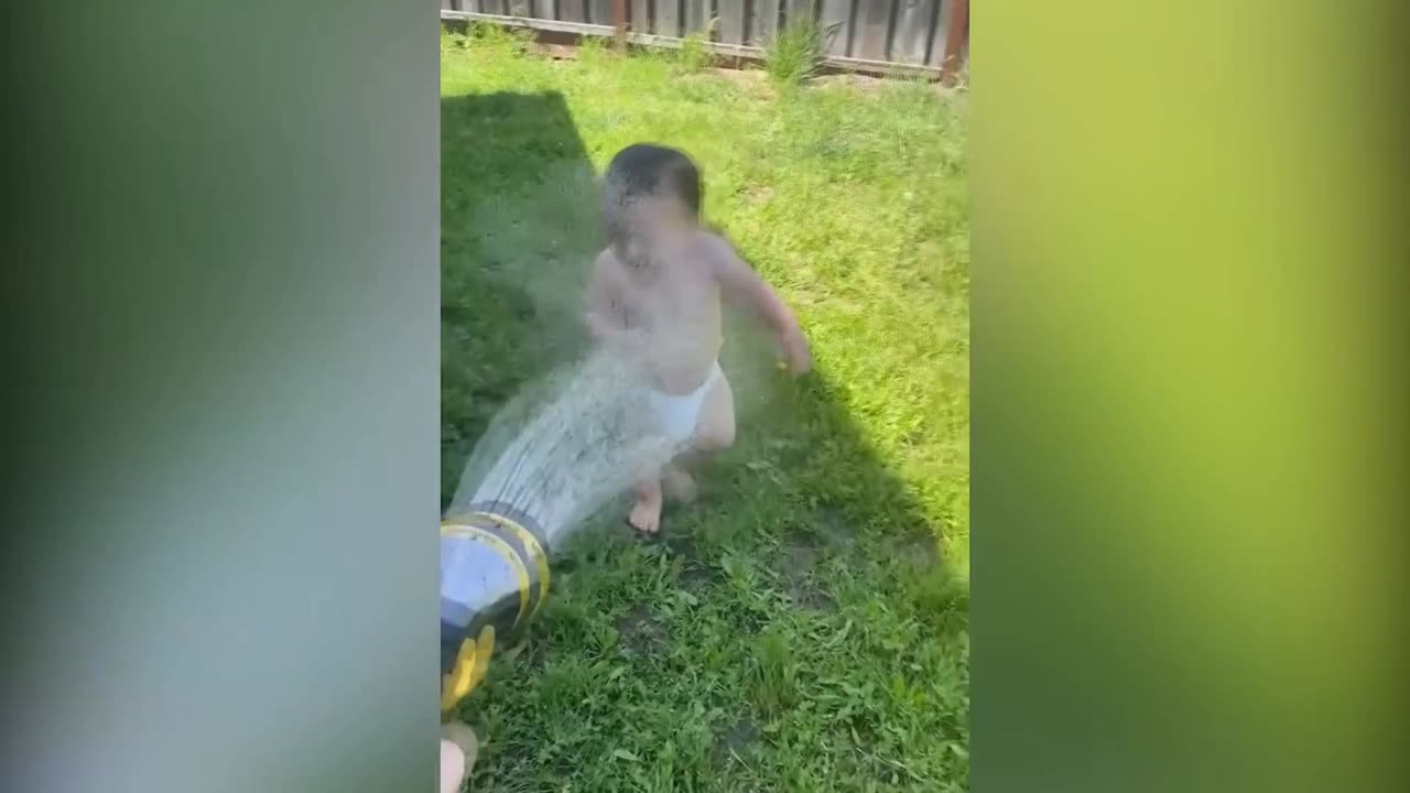 cute baby is playing with water