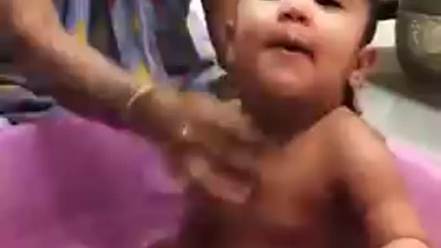 Funny baby playing with water