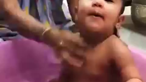 Funny baby playing with water