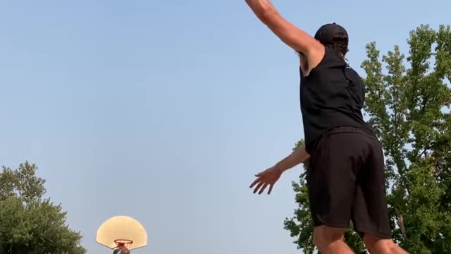Guy Makes Basketball Shot From Half-Court While Balancing Himself Over Rola Bola