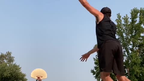 Guy Makes Basketball Shot From Half-Court While Balancing Himself Over Rola Bola