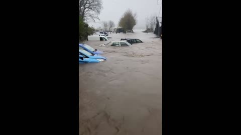 Heavy floods drown cars as river Taff banks burst in Wales