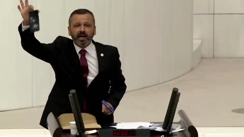 Turkish lawmaker smashes phone with hammer in parliament to protest social media bill