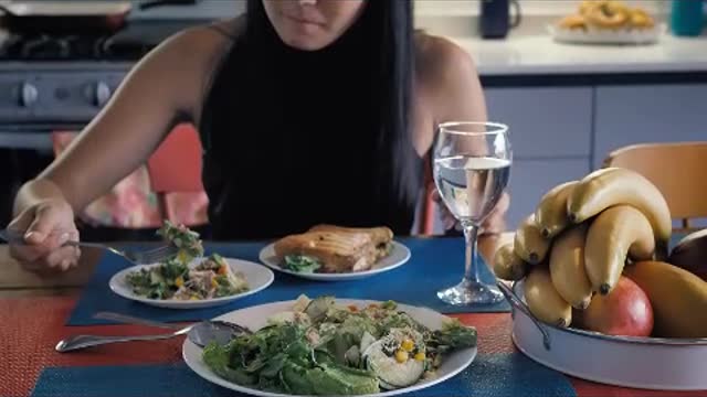 Girl eating salad in her kitchen dining room