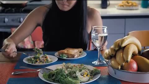 Girl eating salad in her kitchen dining room