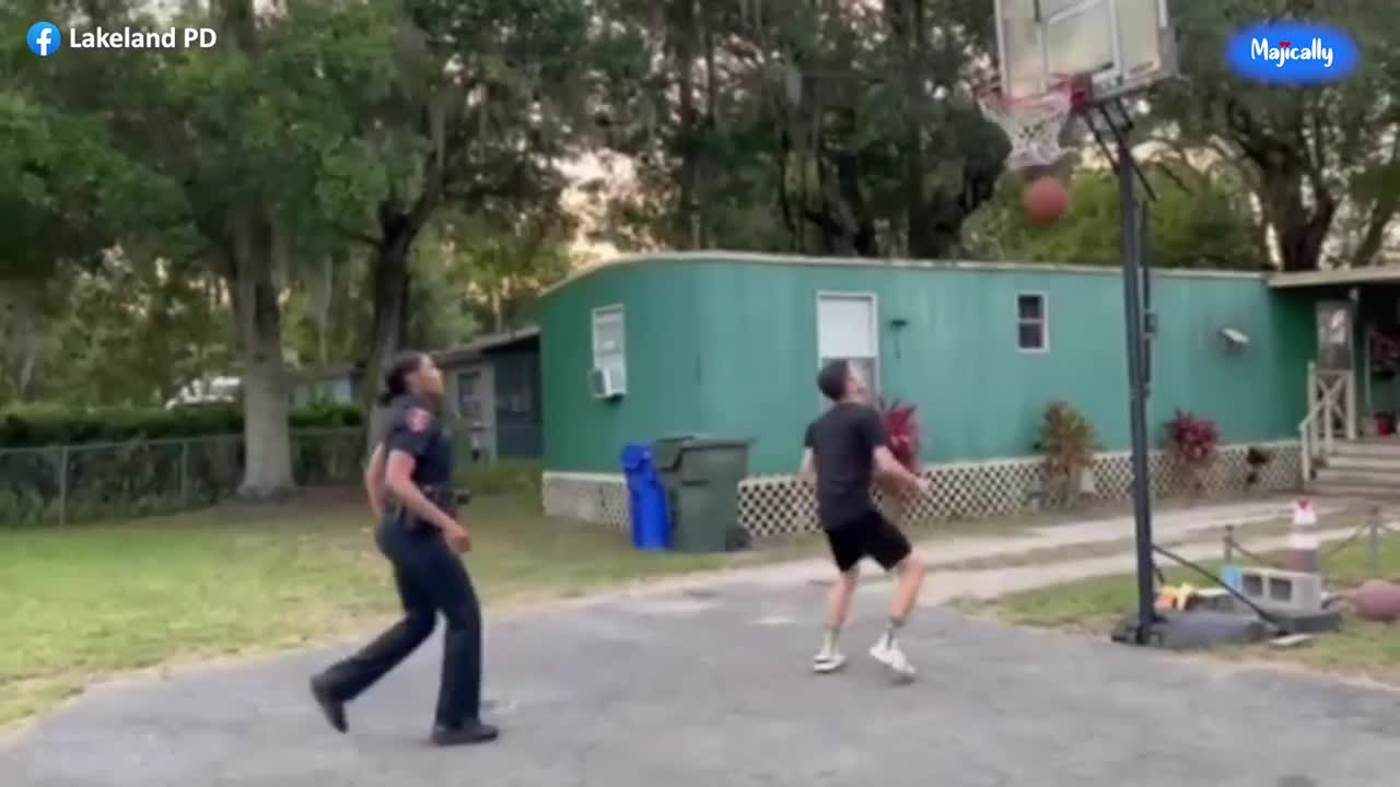 Female police officer schools local teen in game of one on one basketball