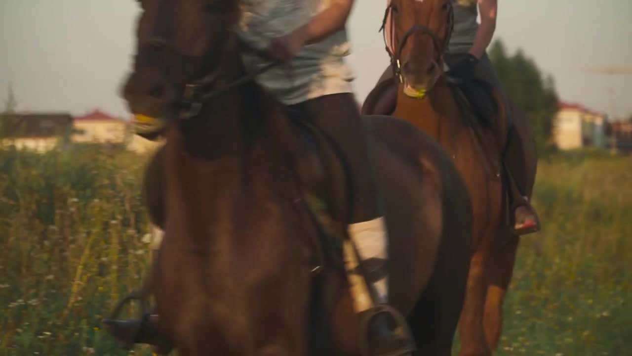 Two girls ride horses