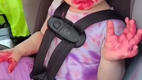 Toddler Sitting in Backseat of Car Makes Mess by Smearing Lipstick All Over Her Face