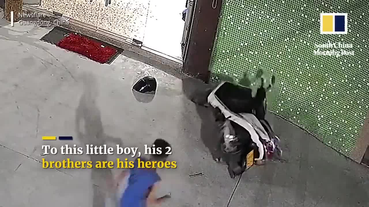 Chinese boys lift scooter to free trapped brother