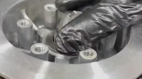 The mechanic carefully assembled the small parts of the engine