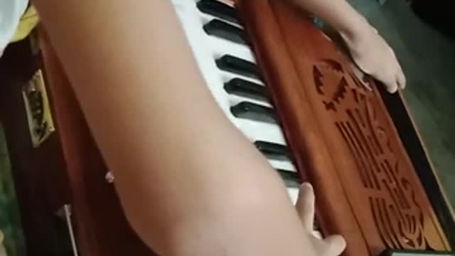 cute baby play harmonium