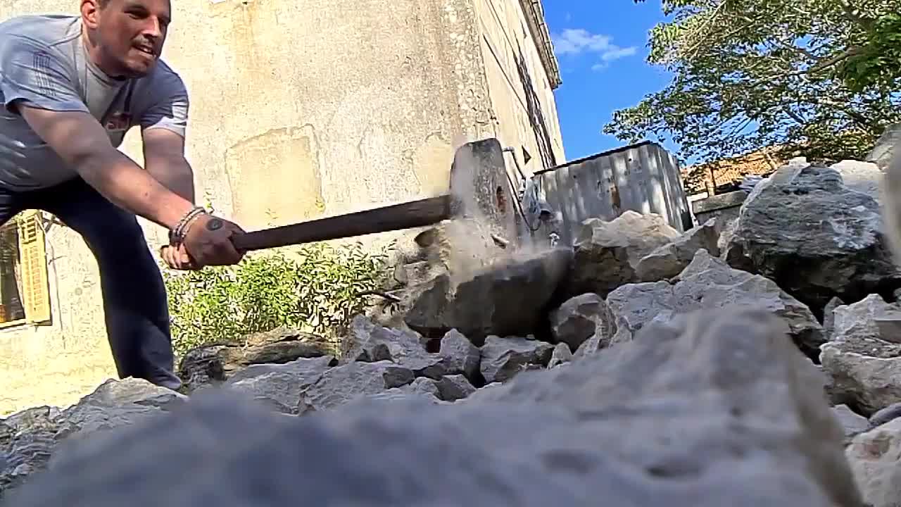 Piece Of Rock Crashes Into Phone As Man Breaks It Using Hammer