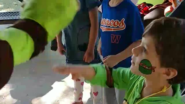 Raphael shows how to get pizza from ice cream kitty freezer at colonial park in West University