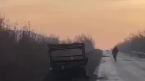 Russian Soldier Attempting to Stop a Vehicle From Driving onto Bridge Rigged with Explosive