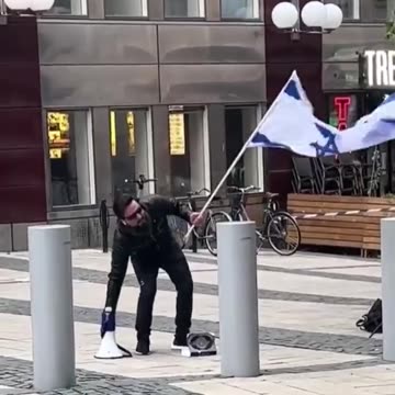 An Iraqi man in Sweden kissed the Israeli flag while stepping on the Quran.