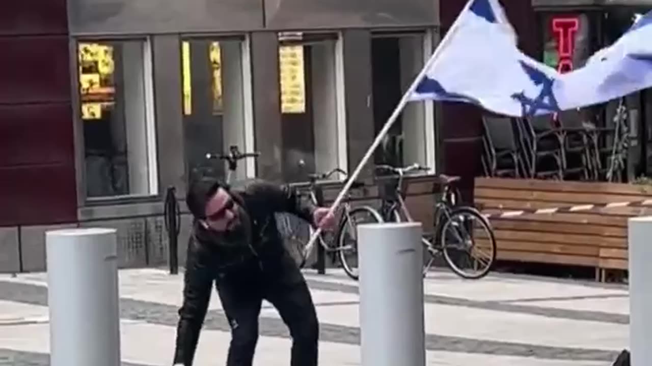 An Iraqi man in Sweden kissed the Israeli flag while stepping on the Quran.