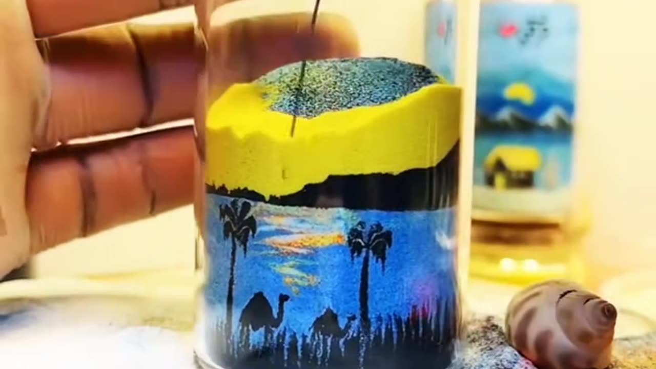 Creative sand painting in a cup, painting the sunset and the beautiful picture of the evening