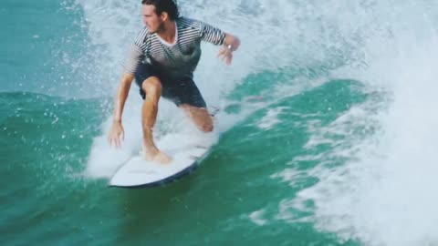 A Male Surfer Riding Skillfully The Sea Waves