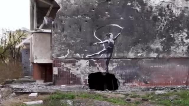 street artist with his works on the walls of houses in Ukraine.