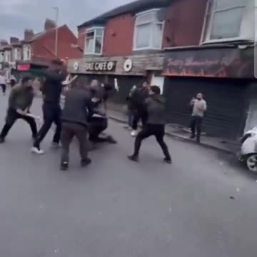 A lone white man is chased through the streets by Muslims and attacked with pieces of wood