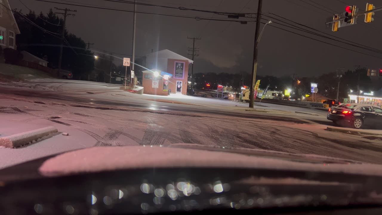 Vehicles Struggle to Stop at Icy Intersection