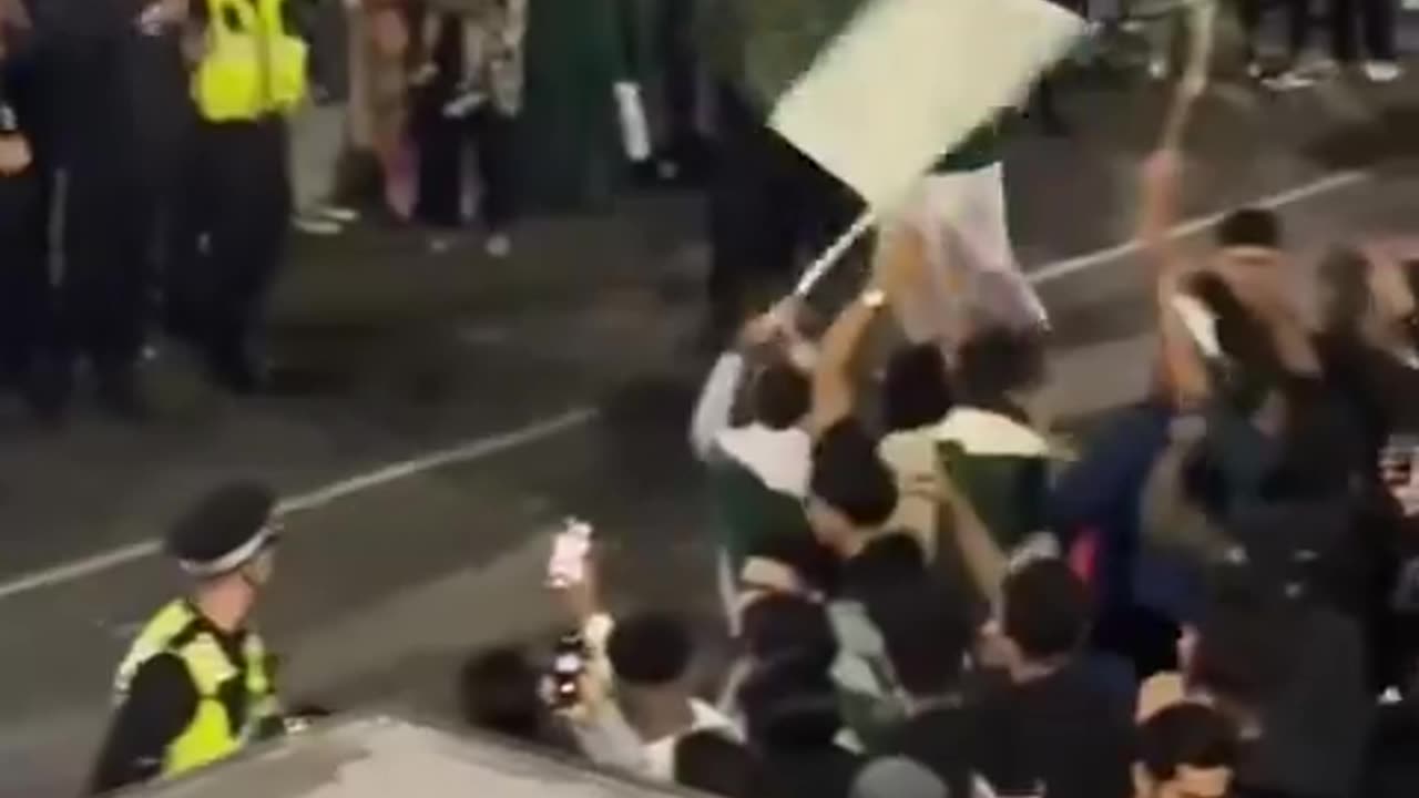 police dancing with a load of Pakistani Muslims in Manchester.