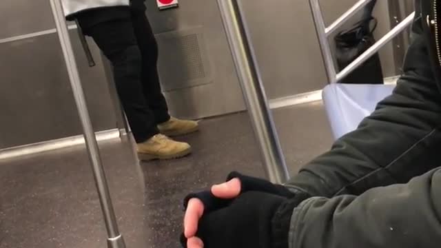 Man grey sweater exercise strings on subway