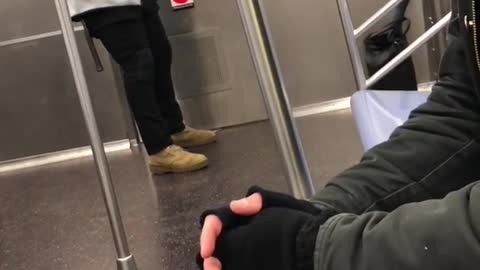 Man grey sweater exercise strings on subway