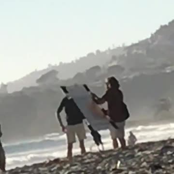 A man comments on a couples wedding pictures at the beach