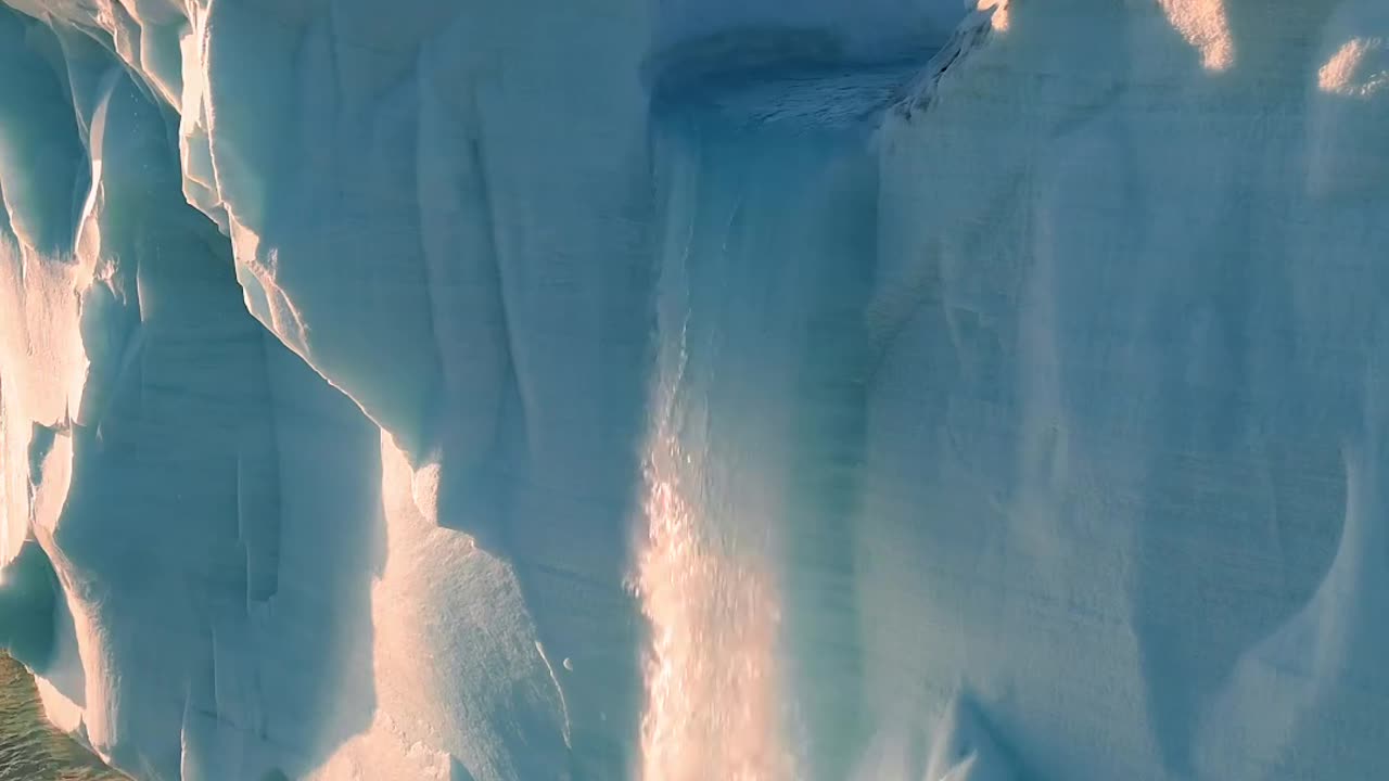 A glacial waterfall that falls straight into the ocean