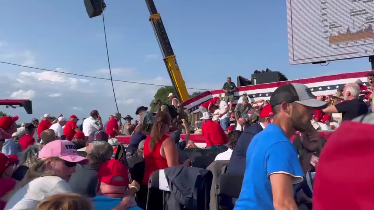 Body of civilian victim being removed from stands.