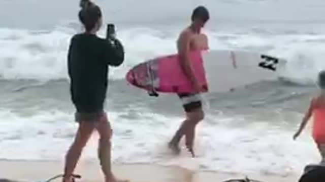 Guy walks into ocean with board just to get picture taken